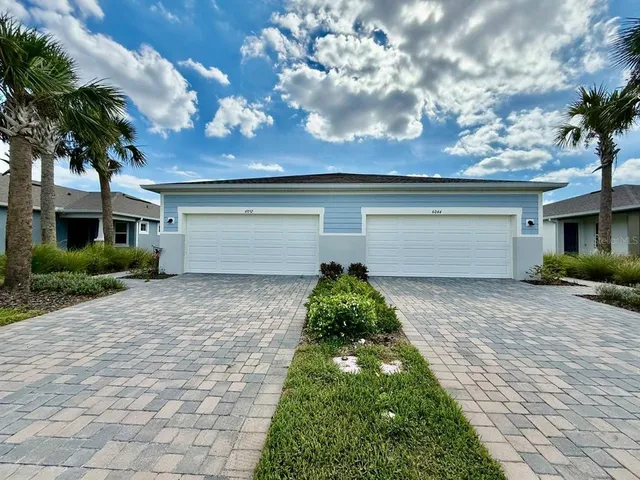 a front view of a house with a yard and a garage