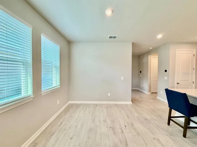 a view of a room with wooden floor and a window