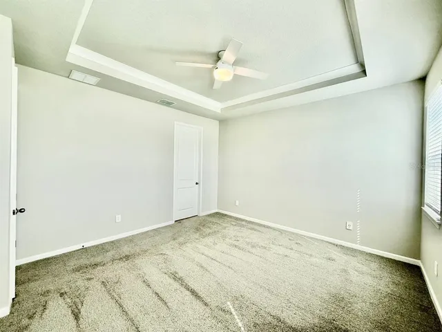 a view of a room with a ceiling fan