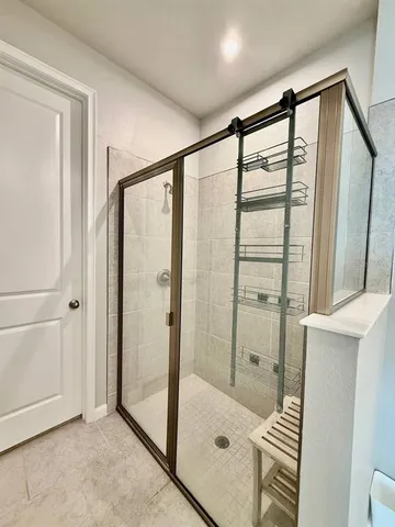 a bathroom with a shower and a tub