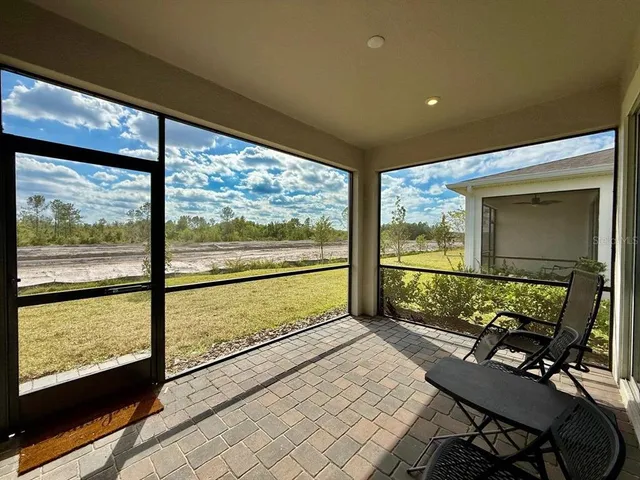 a view of two chairs in a room next to a window