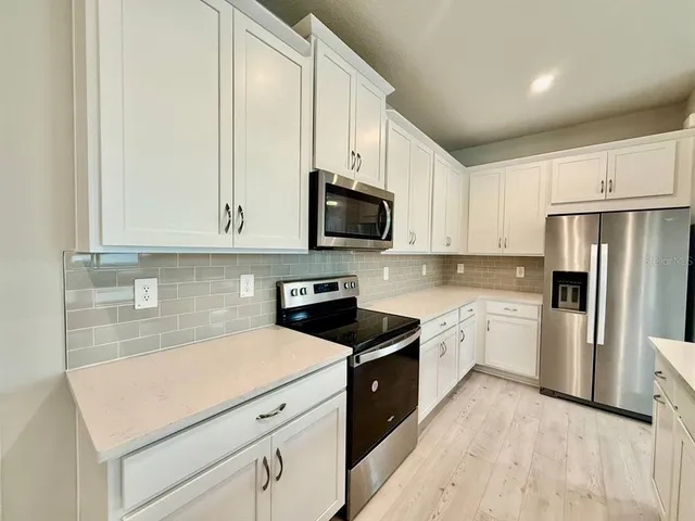 a kitchen with a sink a stove and refrigerator