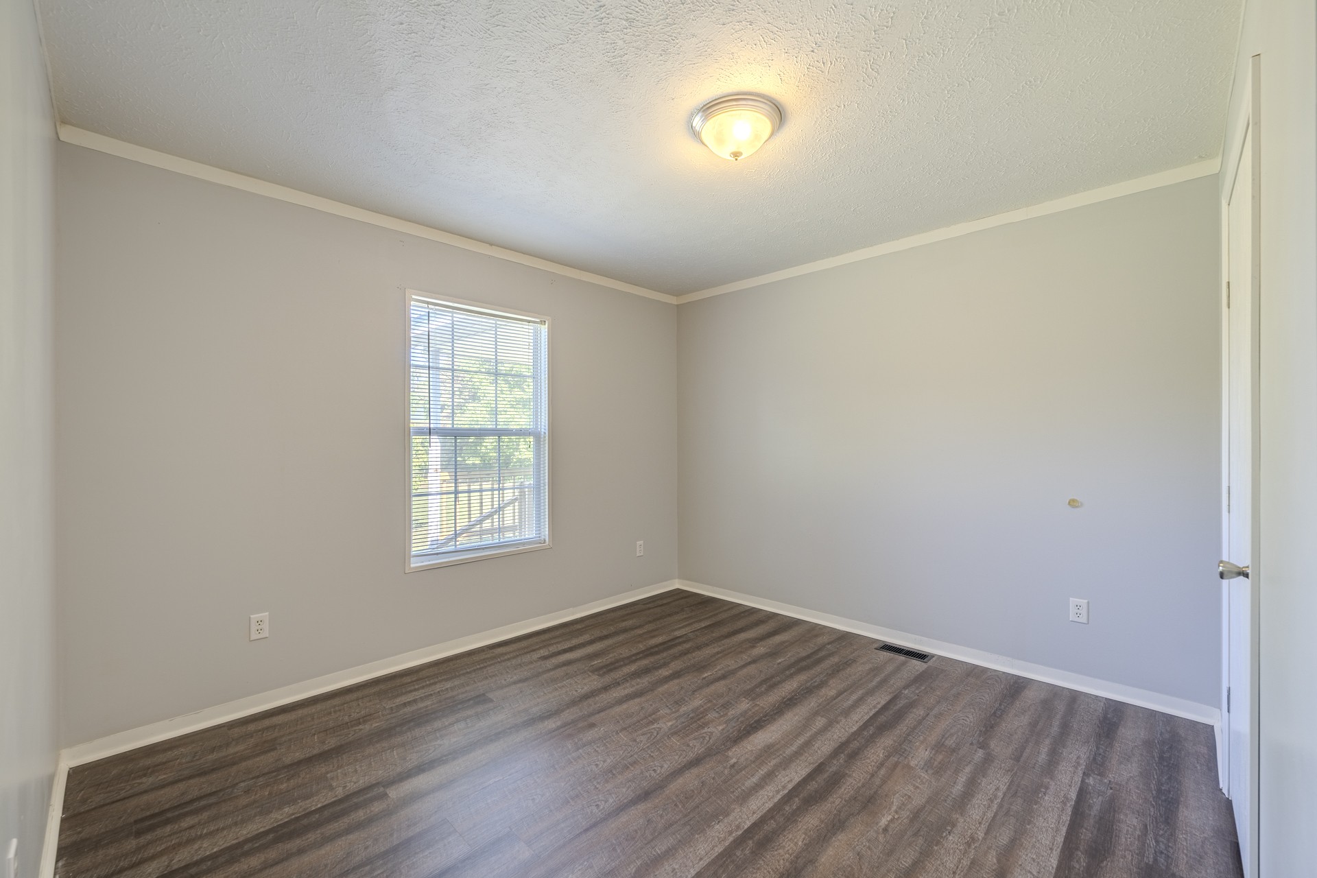 1125 Clifft Road Bolivar, TN 38008 - Photo 36 of 78 an empty room with wooden floor and windows