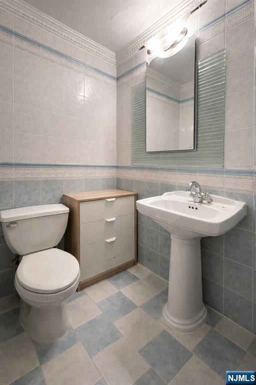200 Old Palisade Road, Unit 18D Fort Lee, NJ 07024 - Photo 11 of 14 a bathroom with a sink toilet and a mirror