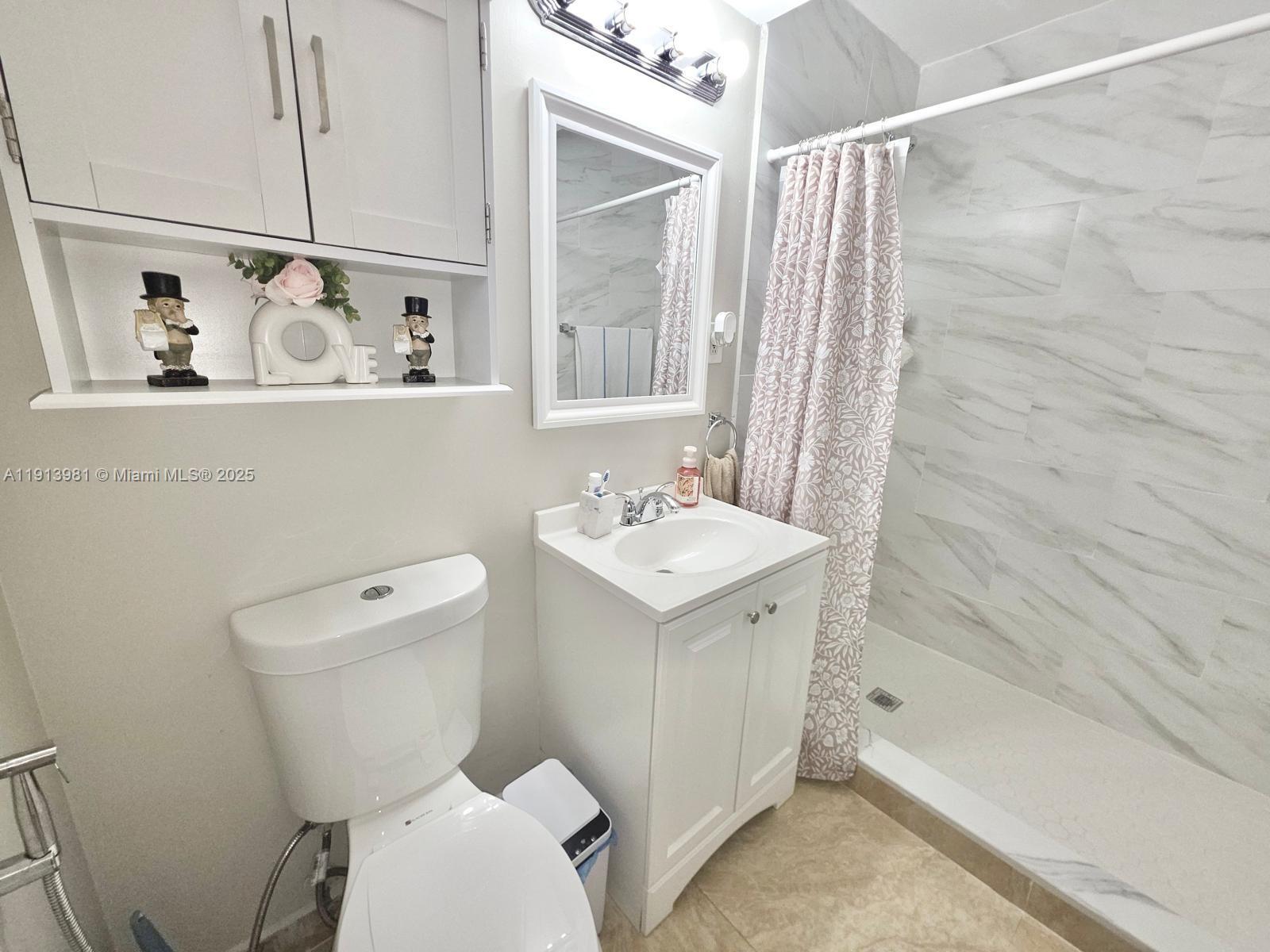 15871 Southwest 86th Terrace Miami, FL 33193 - Photo 13 of 30 a bathroom with a sink a toilet and shower