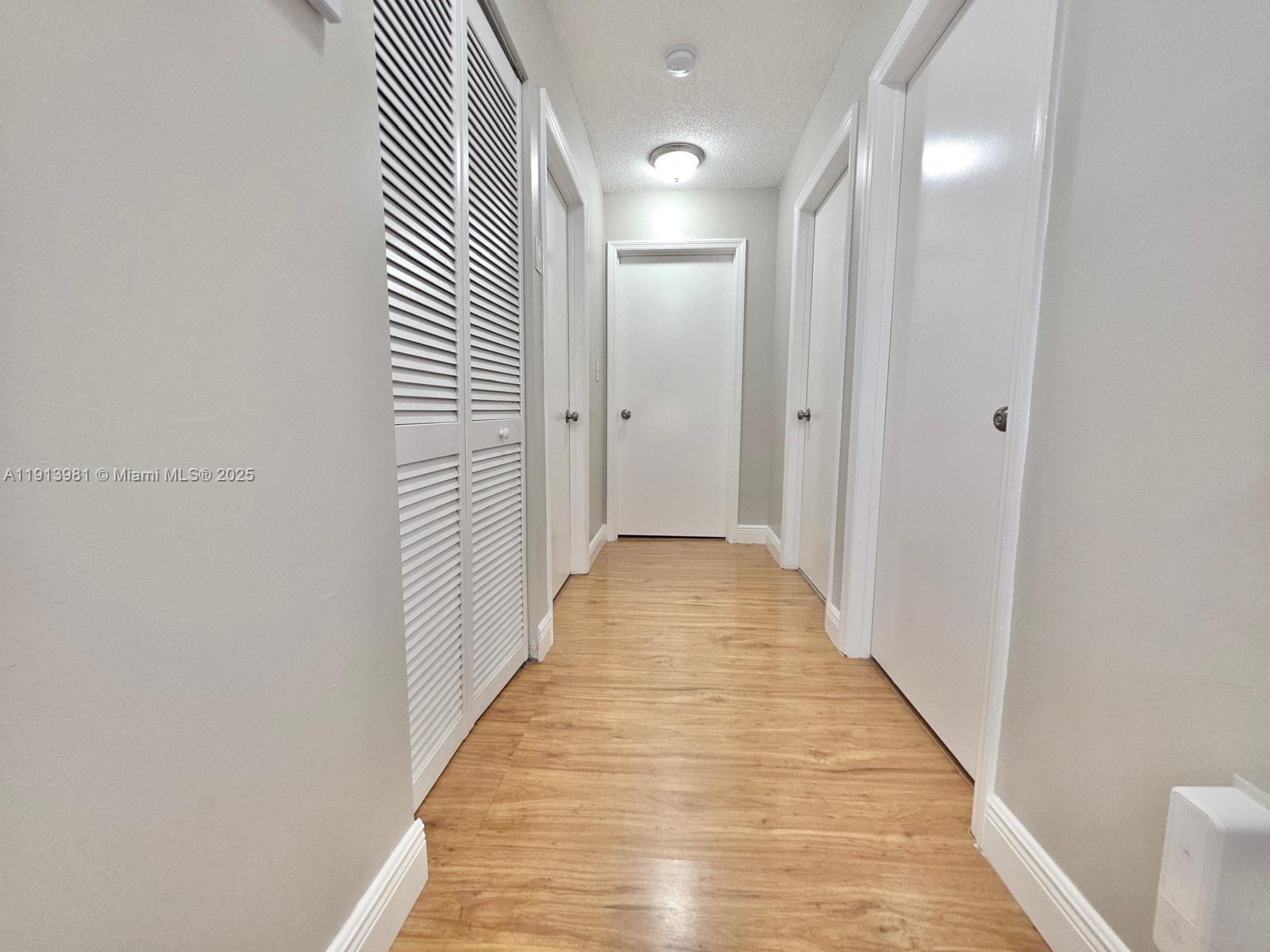 15871 Southwest 86th Terrace Miami, FL 33193 - Photo 18 of 30 a view of a hallway with wooden floor