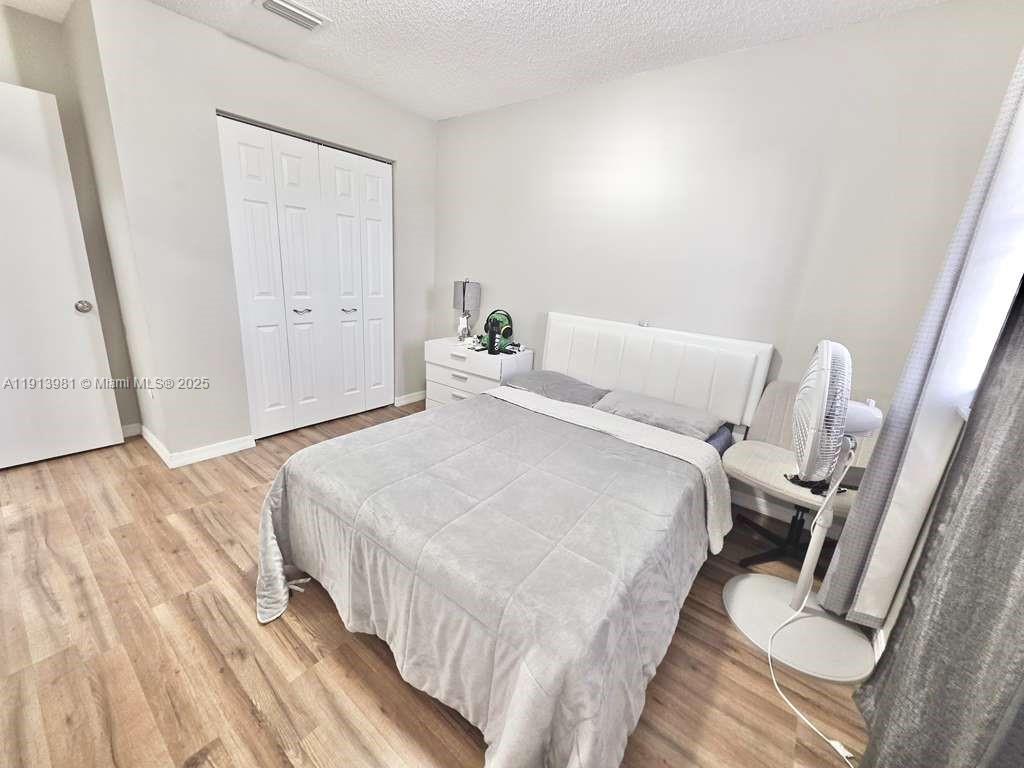 15871 Southwest 86th Terrace Miami, FL 33193 - Photo 19 of 30 a bed room with a bed and a rug