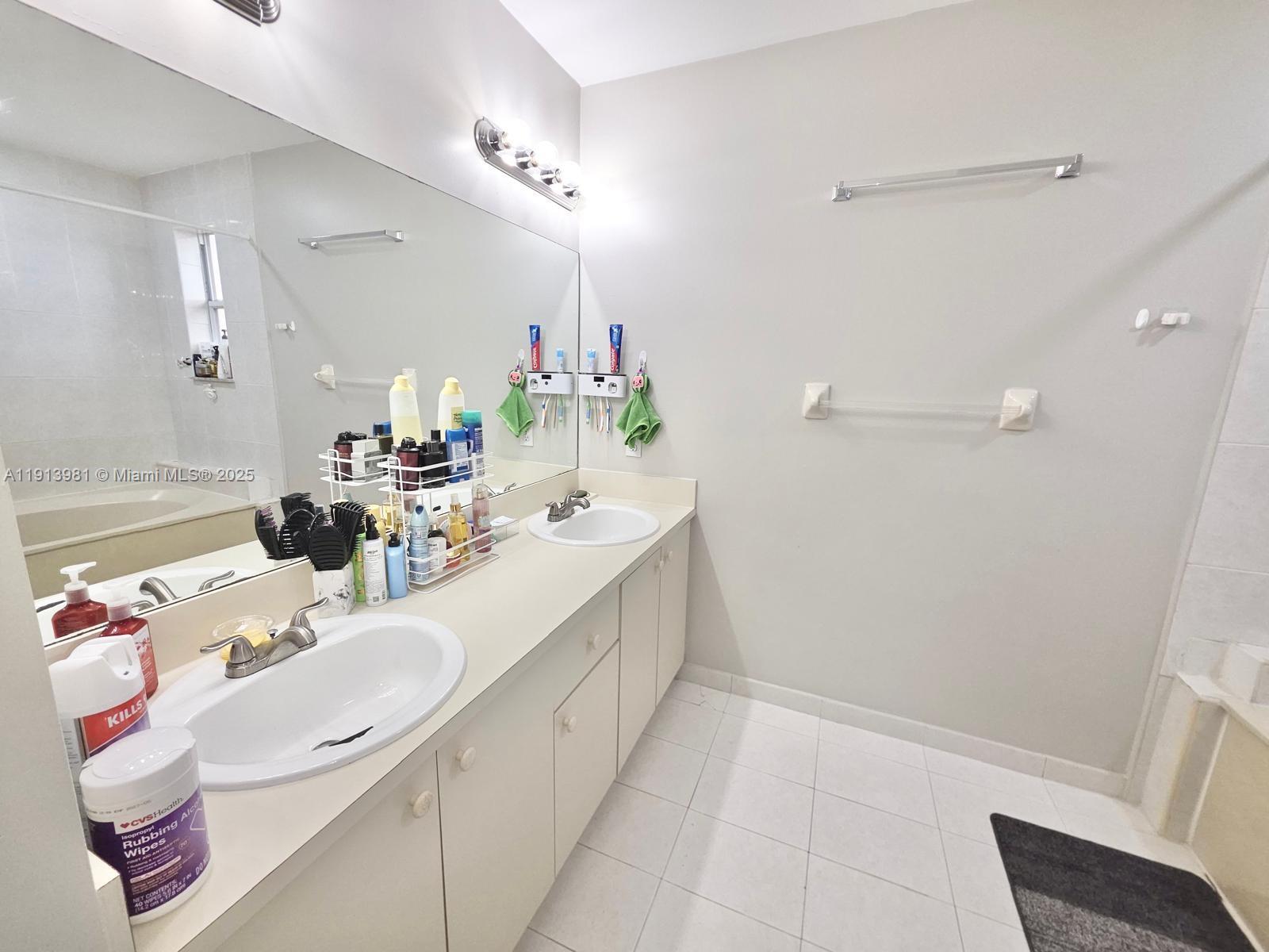 15871 Southwest 86th Terrace Miami, FL 33193 - Photo 25 of 30 a bathroom with a sink and a mirror