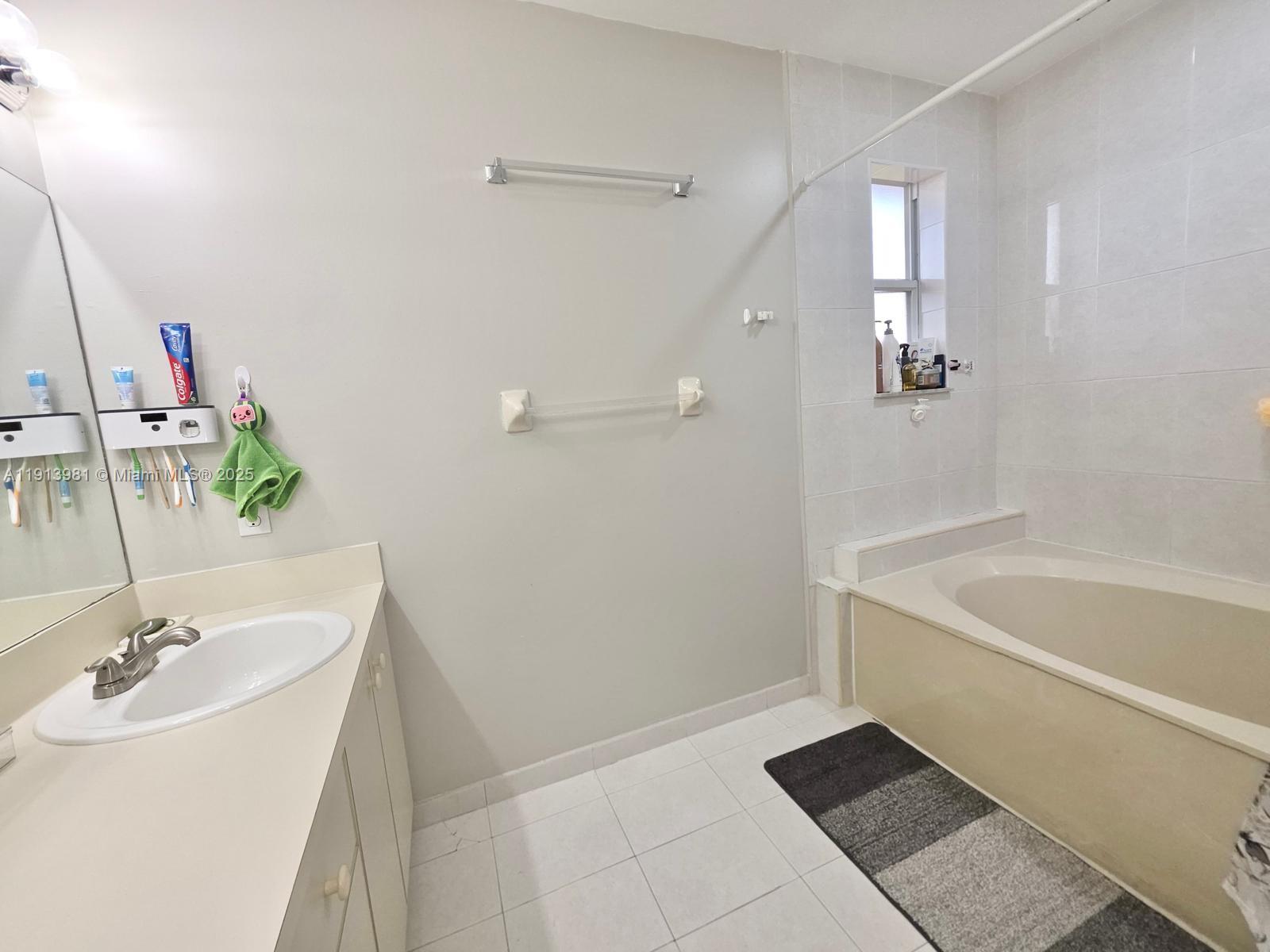 15871 Southwest 86th Terrace Miami, FL 33193 - Photo 26 of 30 a bathroom with a tub sink and mirror