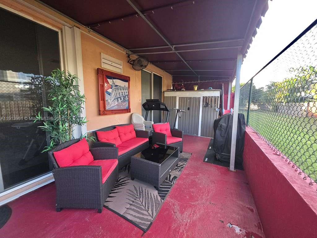 15871 Southwest 86th Terrace Miami, FL 33193 - Photo 27 of 30 a view of a chairs and tables in the balcony