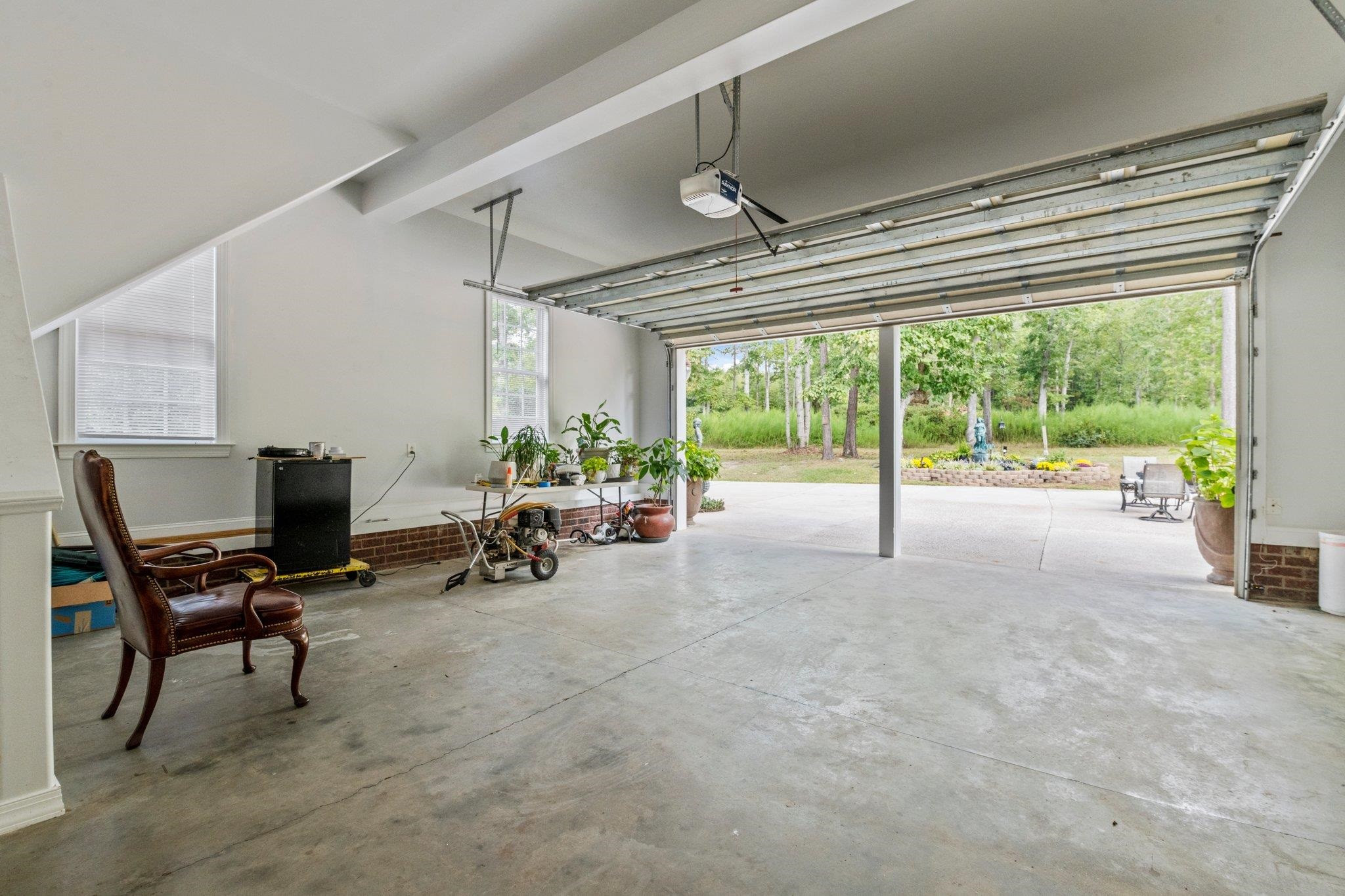 525 Eatmon Road Zebulon, NC 27597 - Photo 20 of 30 Oversized 2 car garage that leads out to the patio. Stair access to the apartment above. Garage