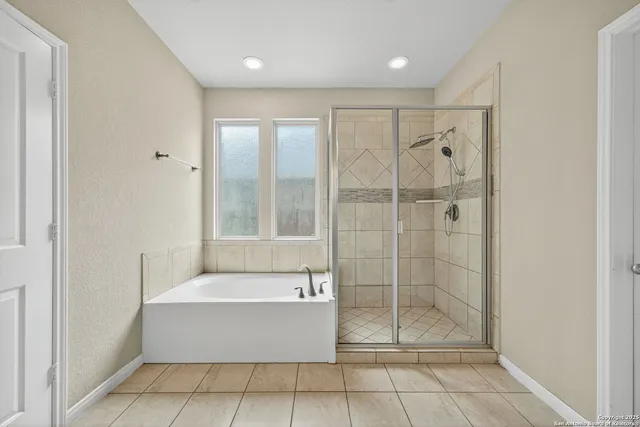 a bathroom with a bathtub and a shower