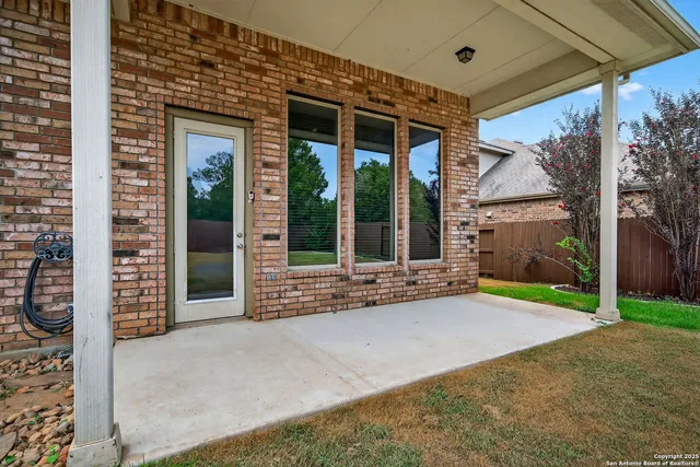 a view of a house with a yard and large tree