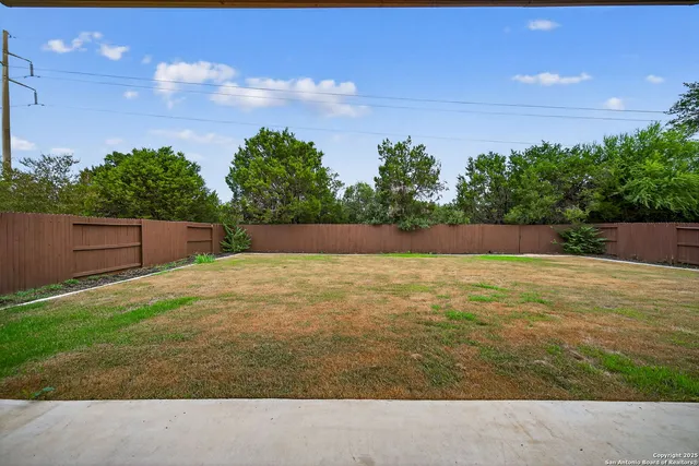 a view of yard with swimming pool and green space