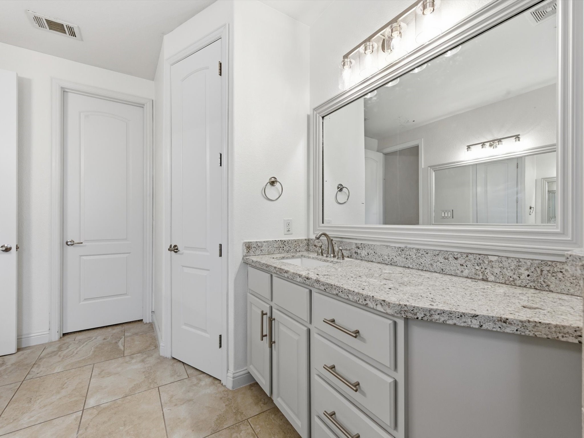6109 Stillman Street Houston, TX 77007 - Photo 14 of 28 a bathroom with a granite countertop sink and a mirror