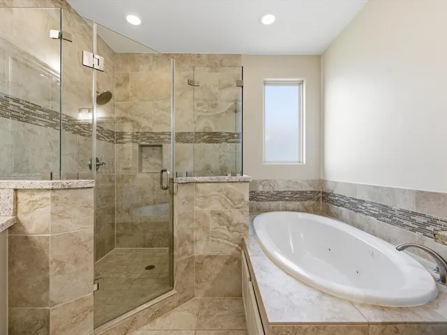 a bathroom with a bathtub and shower
