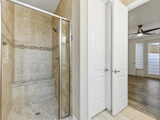 a bathroom with a glass shower door