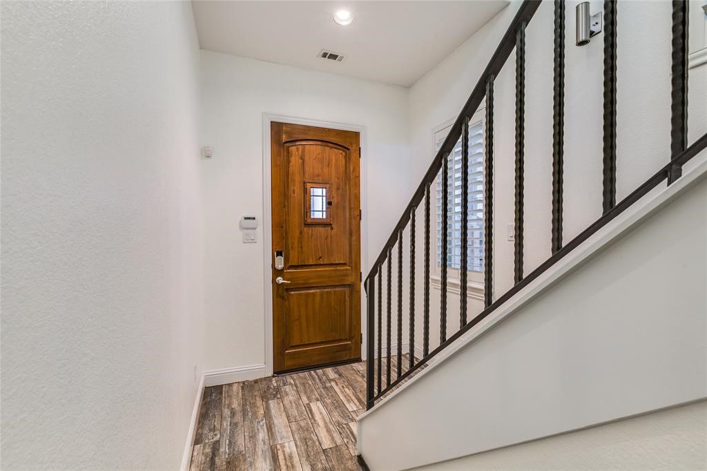6109 Stillman Street Houston, TX 77007 - Photo 10 of 28 a view of a hallway with wooden floor and staircase