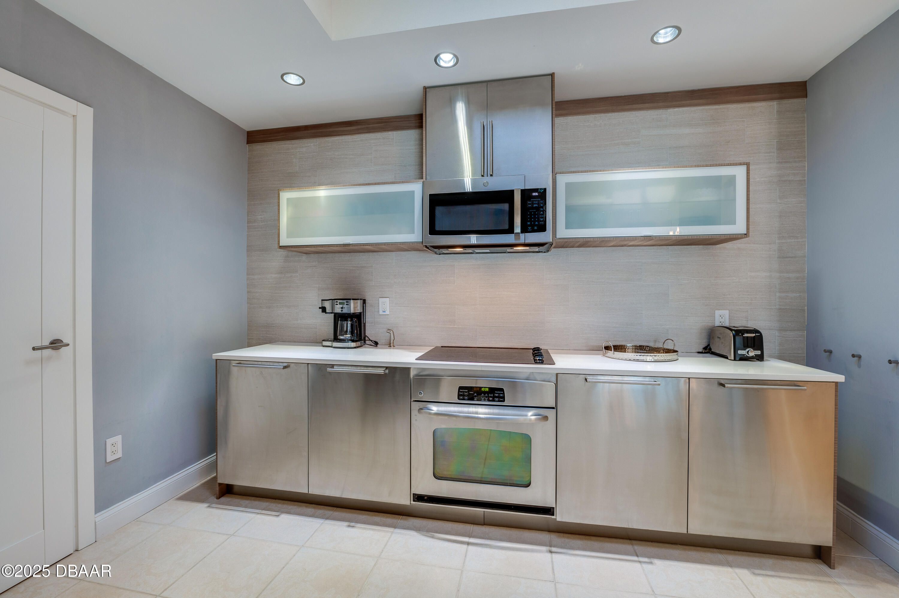 241 Riverside Drive, Unit 2603 Holly Hill, FL 32117 - Photo 20 of 71 a kitchen with a stove and a microwave