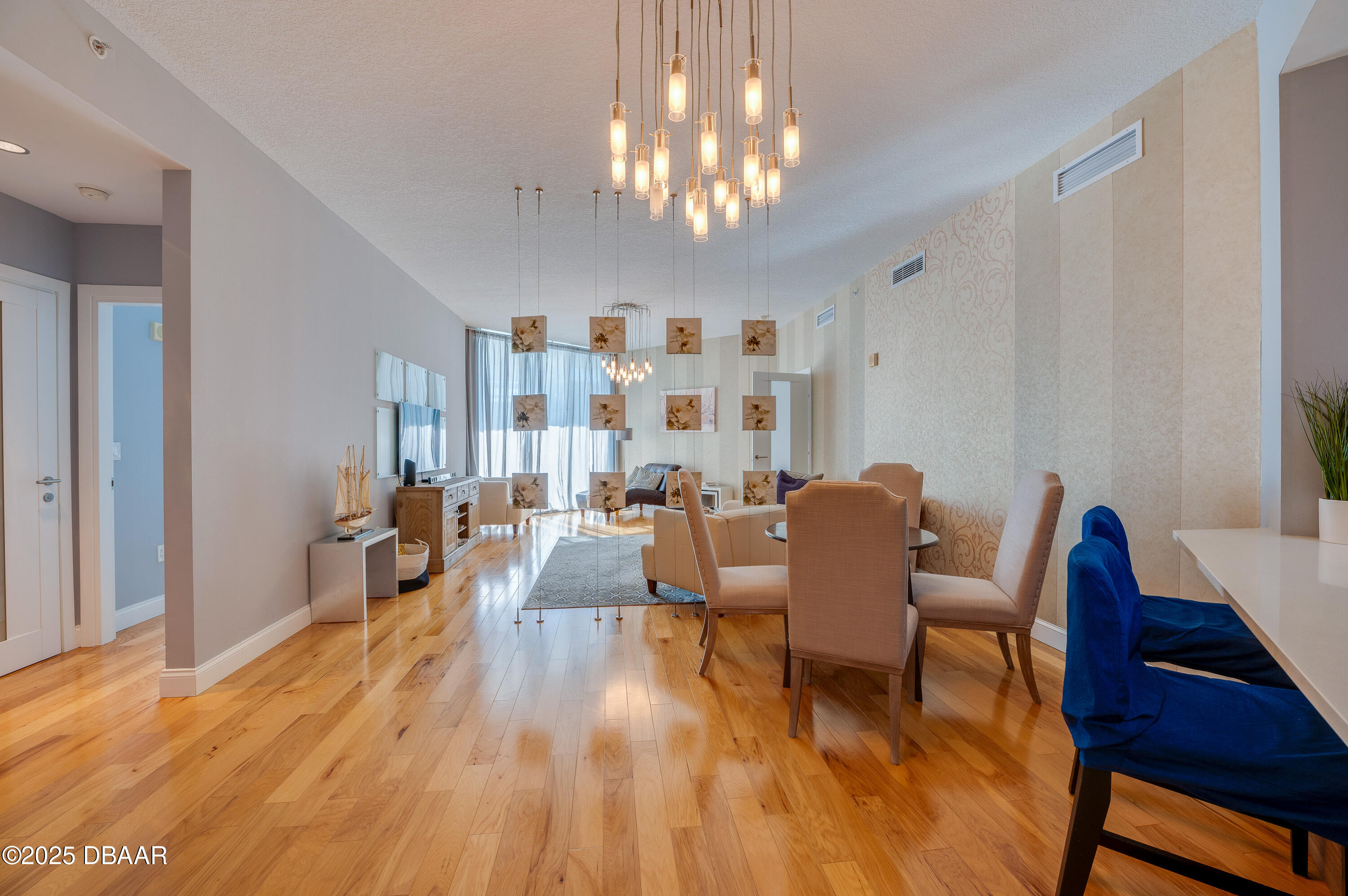 241 Riverside Drive, Unit 2603 Holly Hill, FL 32117 - Photo 24 of 71 a view of a dining room with furniture a chandelier and wooden floor
