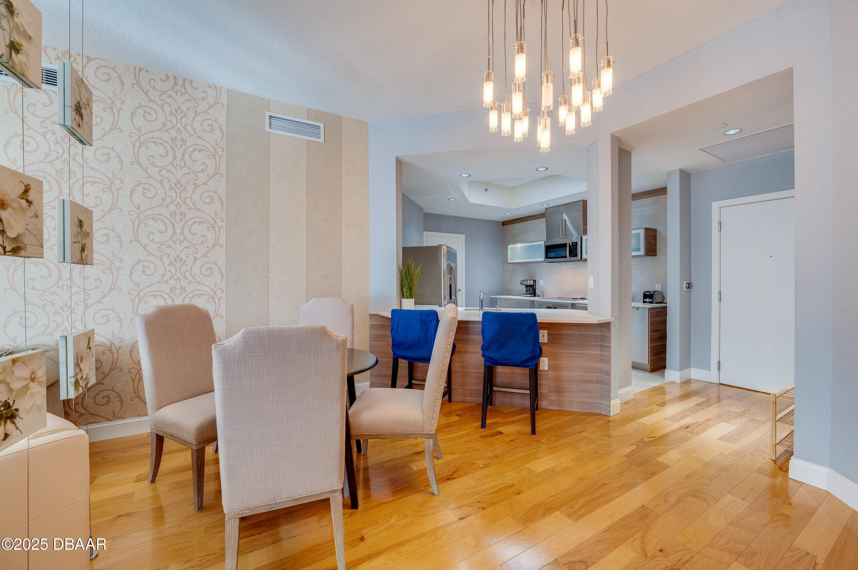 241 Riverside Drive, Unit 2603 Holly Hill, FL 32117 - Photo 25 of 71 a view of a dining room with furniture and a chandelier