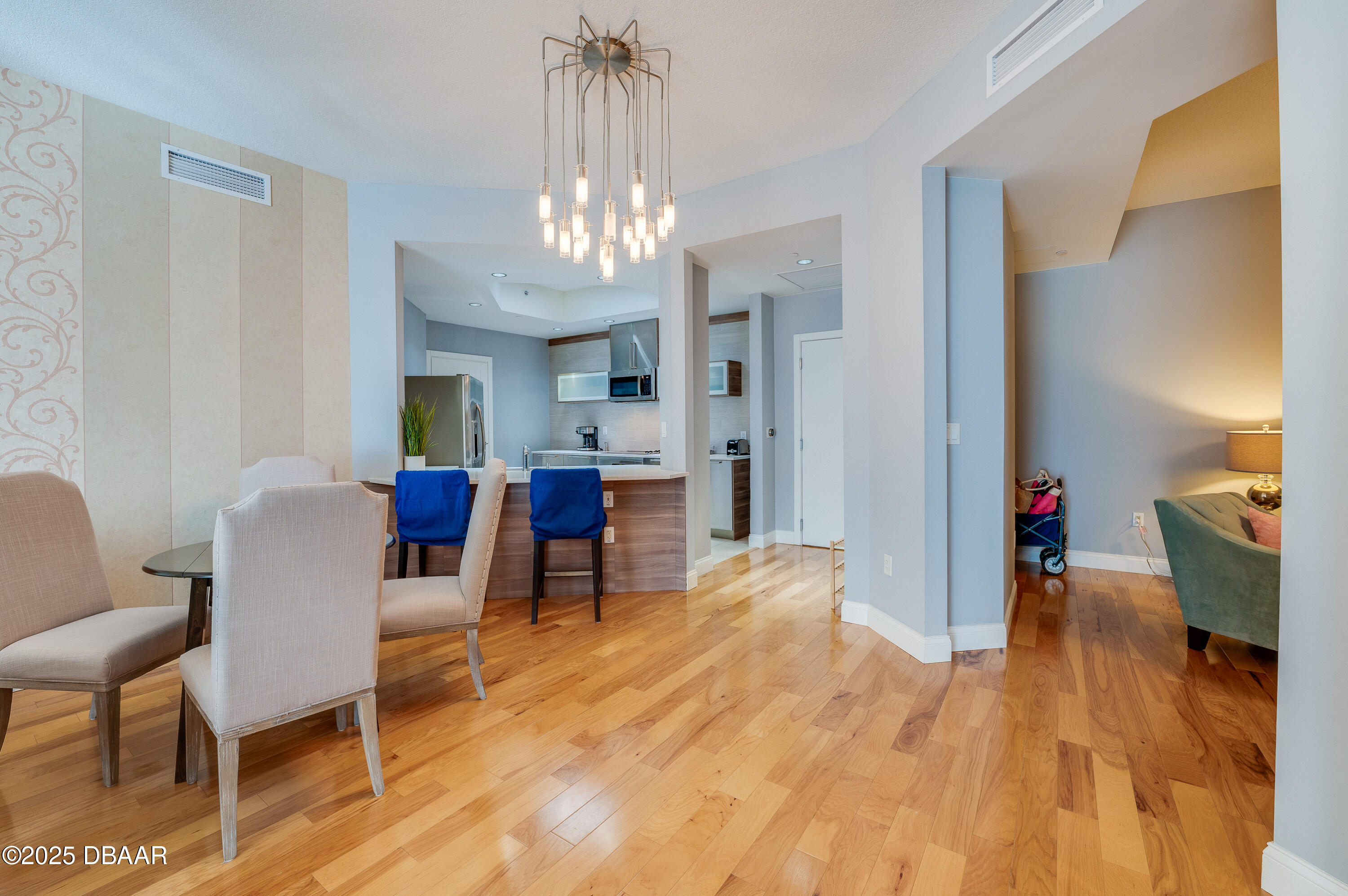 241 Riverside Drive, Unit 2603 Holly Hill, FL 32117 - Photo 26 of 71 a view of a dining room with furniture a chandelier and wooden floor