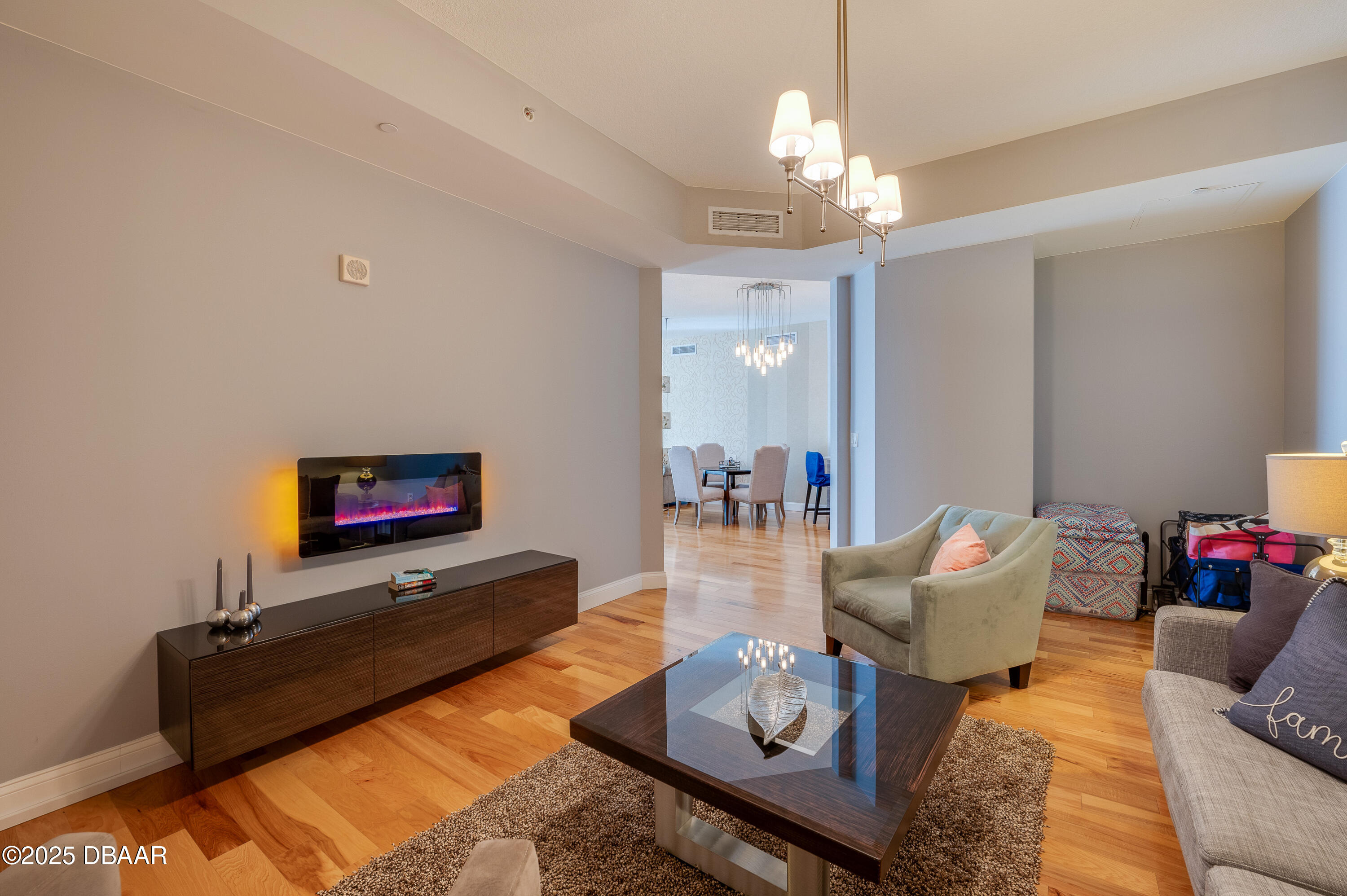 241 Riverside Drive, Unit 2603 Holly Hill, FL 32117 - Photo 31 of 71 a living room with furniture and a chandelier