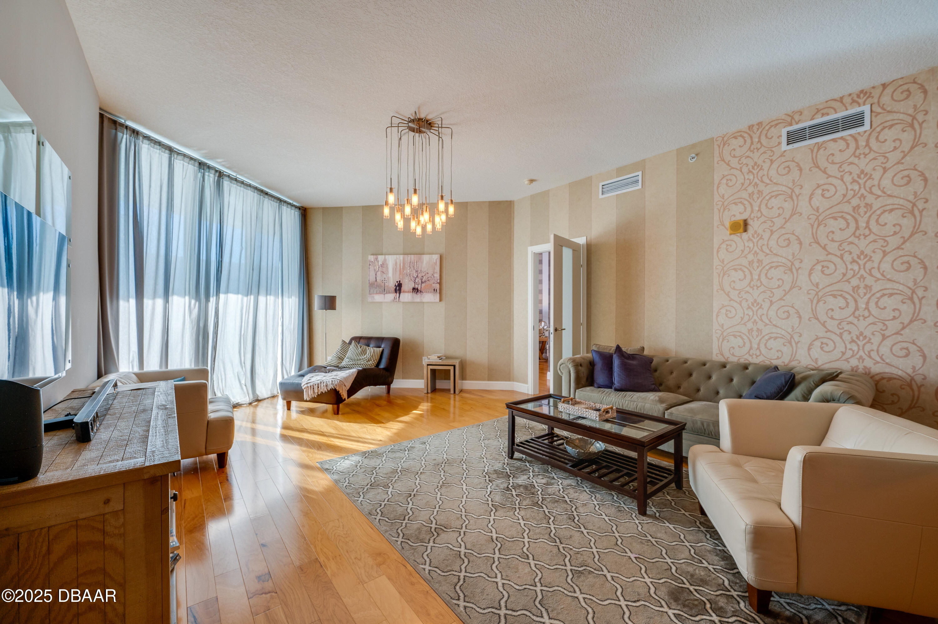 241 Riverside Drive, Unit 2603 Holly Hill, FL 32117 - Photo 32 of 71 a living room with furniture and a chandelier