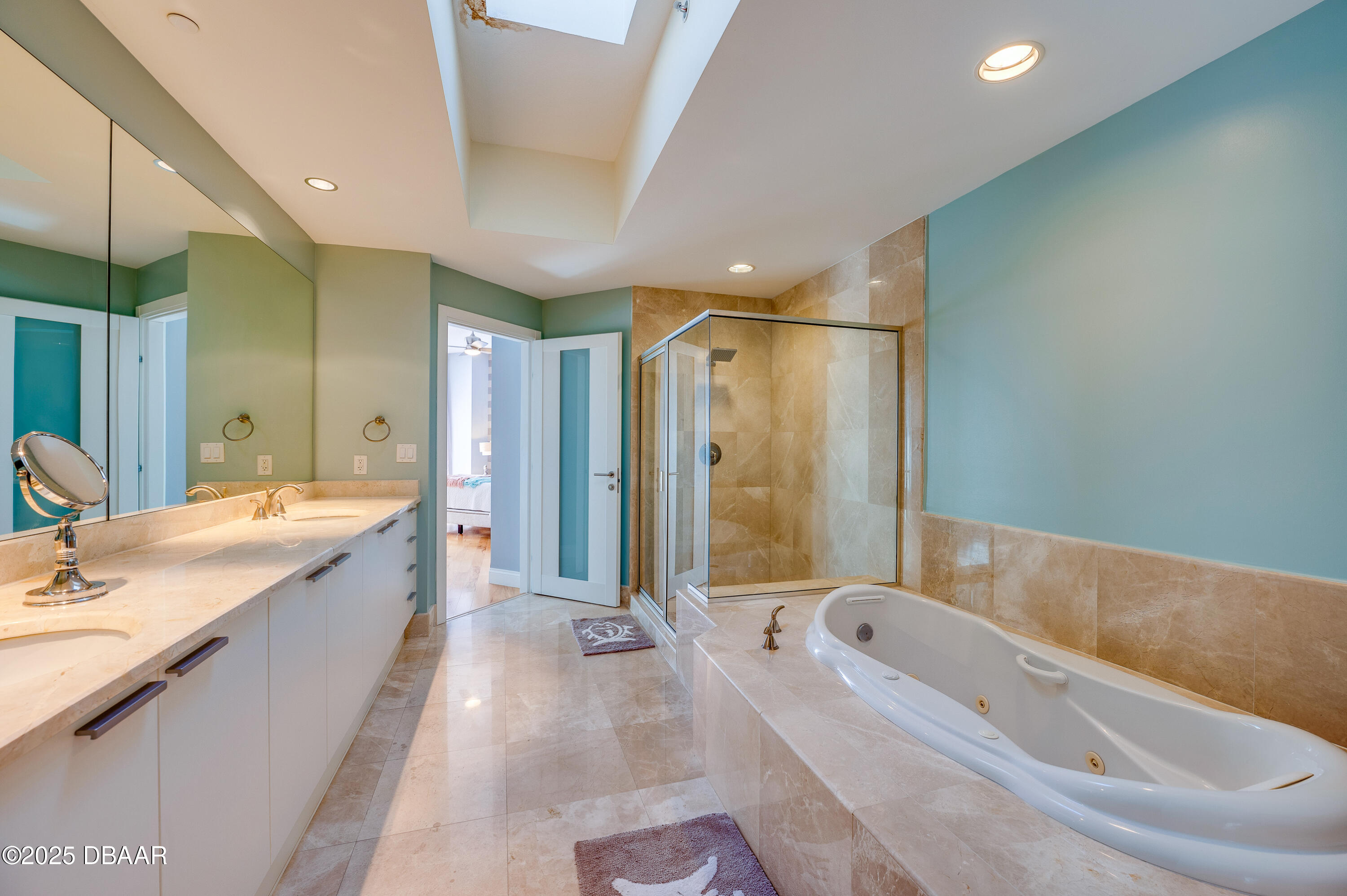 241 Riverside Drive, Unit 2603 Holly Hill, FL 32117 - Photo 38 of 71 a bathroom with a granite countertop tub a double vanity sink and mirror