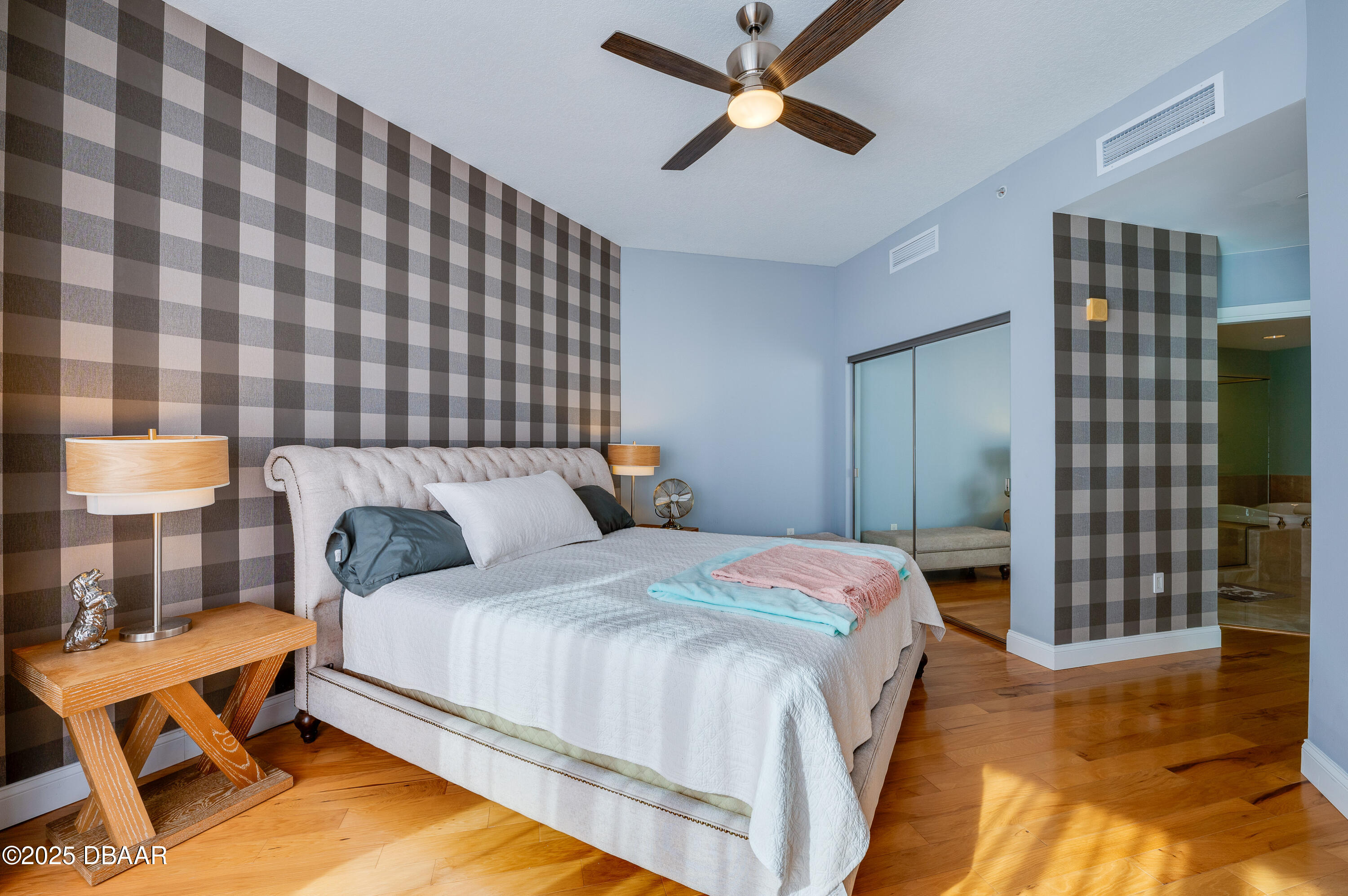 241 Riverside Drive, Unit 2603 Holly Hill, FL 32117 - Photo 40 of 71 a bedroom with a bed and a chandelier
