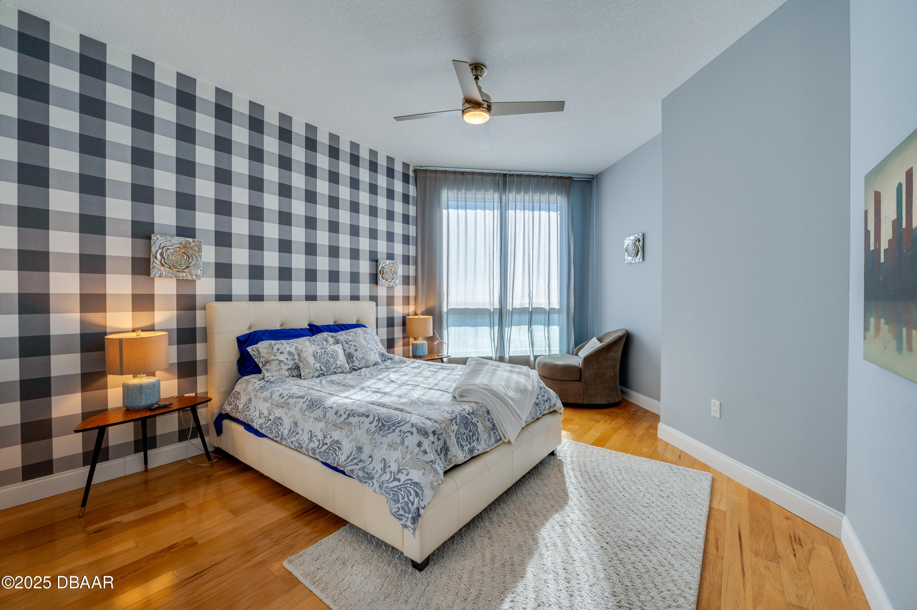 241 Riverside Drive, Unit 2603 Holly Hill, FL 32117 - Photo 45 of 71 a bedroom with a bed lamp and a large window