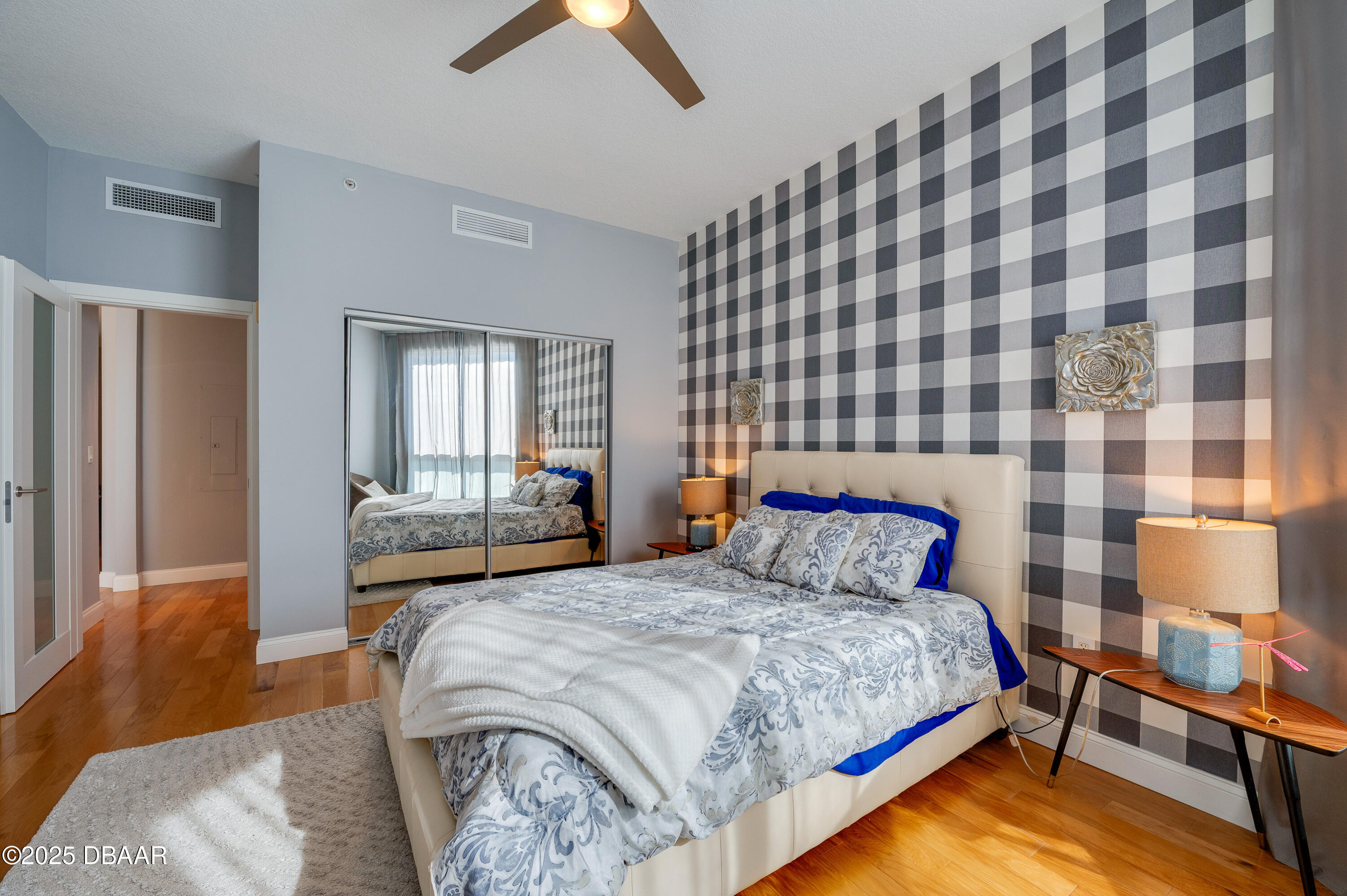241 Riverside Drive, Unit 2603 Holly Hill, FL 32117 - Photo 47 of 71 a bedroom with a bed and wooden floor