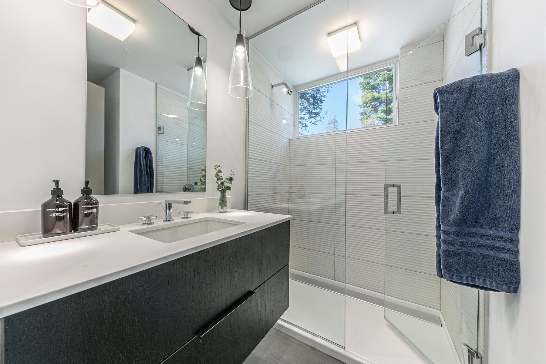 260 Palisades Circle Olympic Valley, CA 96146 - Photo 17 of 28 a bathroom with a double vanity sink a mirror and shower