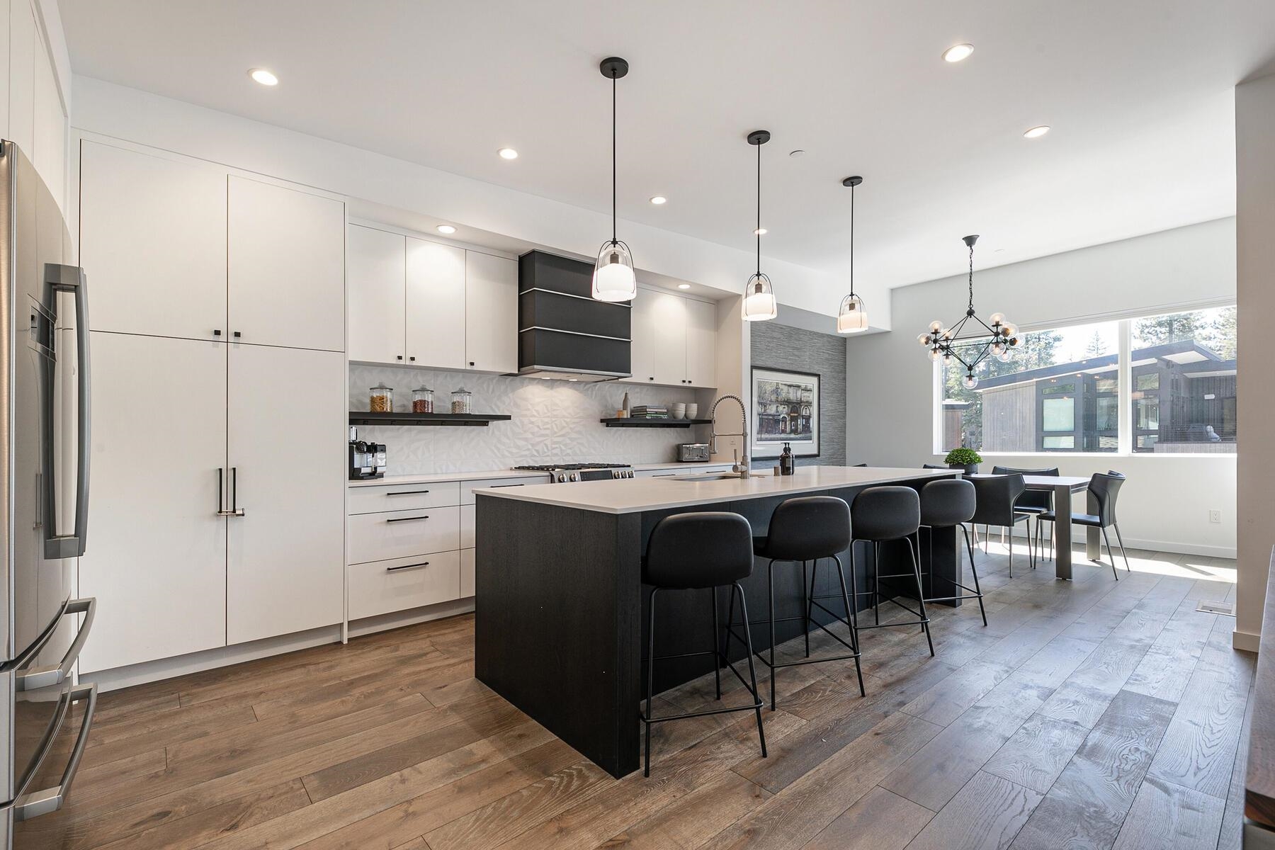 260 Palisades Circle Olympic Valley, CA 96146 - Photo 4 of 28 a open kitchen with stainless steel appliances granite countertop a stove a sink a refrigerator and white cabinets with wooden floor