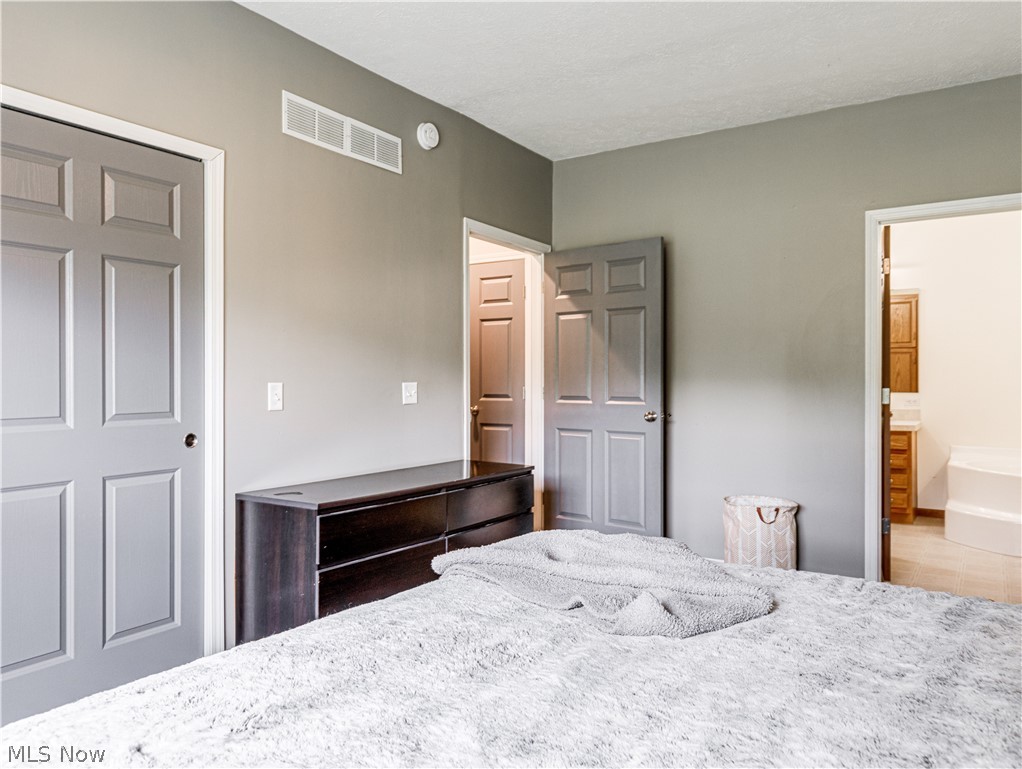 6573 Boneta Road Medina, OH 44256 - Photo 16 of 38 Bedroom featuring wood-type flooring and ensuite bath
