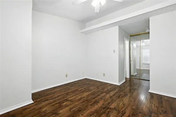 an empty room with wooden floor