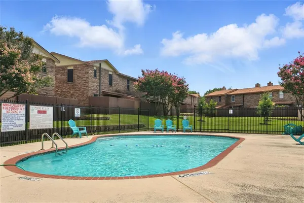 a view of a swimming pool with a yard