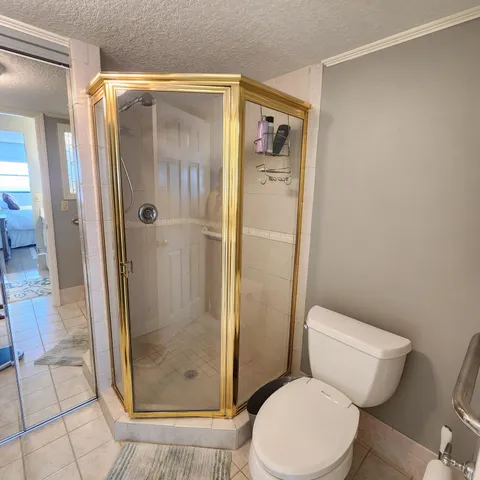 a white toilet sitting next to a bathroom sink