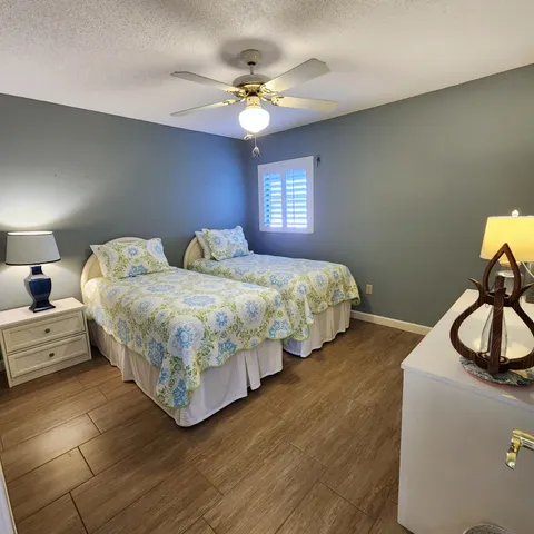a bedroom with two beds and a chandelier