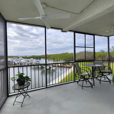 a view of a chairs and table in the balcony