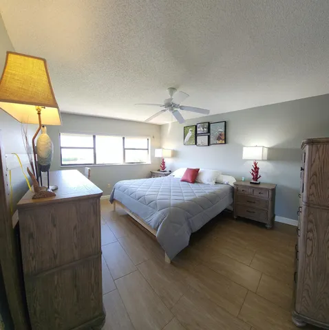 a bedroom with a bed a couch and dresser