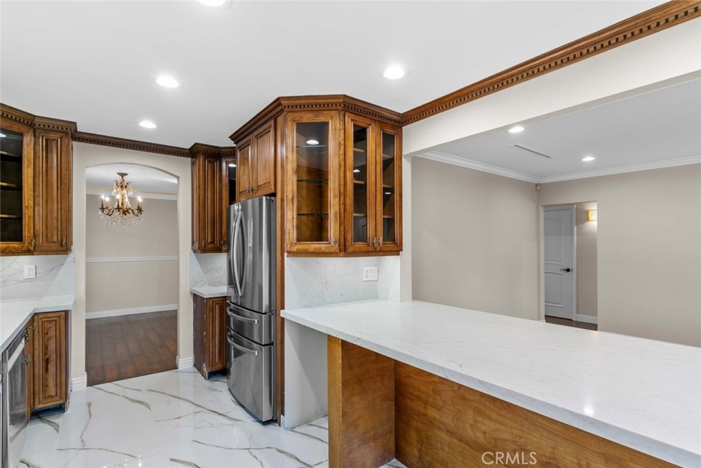 415 Birmingham Road Burbank, CA 91504 - Photo 19 of 61 a kitchen with stainless steel appliances kitchen island granite countertop a refrigerator and a sink