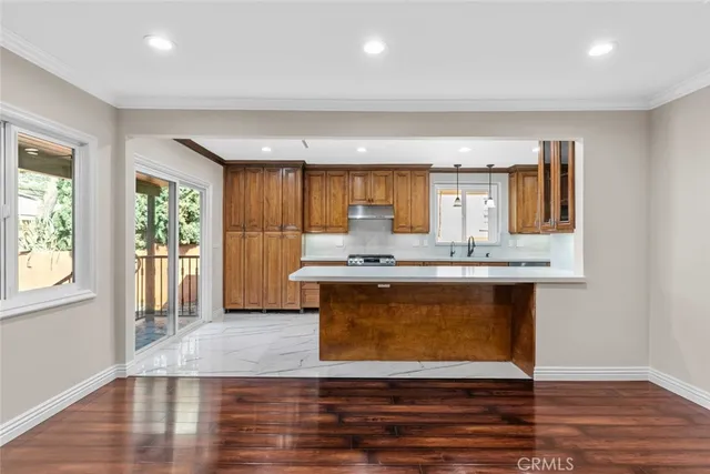 a kitchen with a sink cabinets and wooden floor