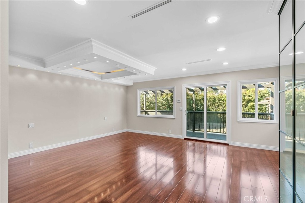 415 Birmingham Road Burbank, CA 91504 - Photo 26 of 61 an empty room with wooden floor and windows