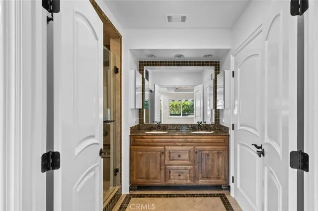 a view of an empty room with wooden floor and entryway
