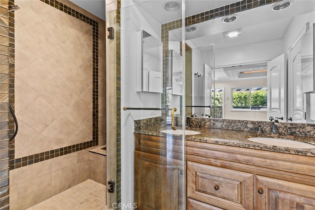 415 Birmingham Road Burbank, CA 91504 - Photo 30 of 61 a bathroom with a double vanity sink and mirror