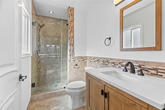 a bathroom with a granite countertop sink a vanity and a mirror
