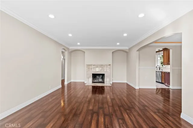 a view of a hallway with wooden floor and a fireplace