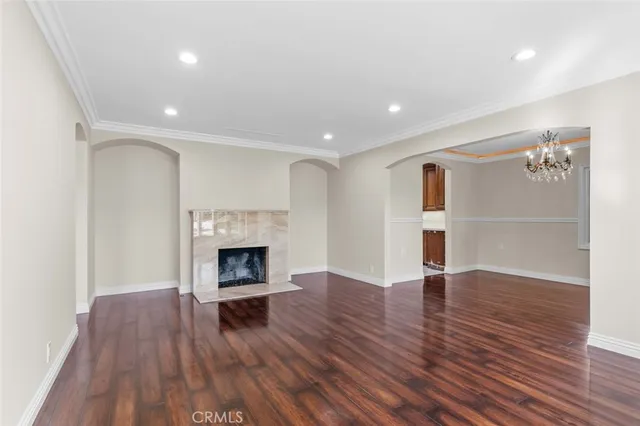 a view of a livingroom with wooden floor and a fireplace