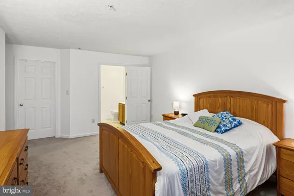 a bedroom with a bed and a potted plant